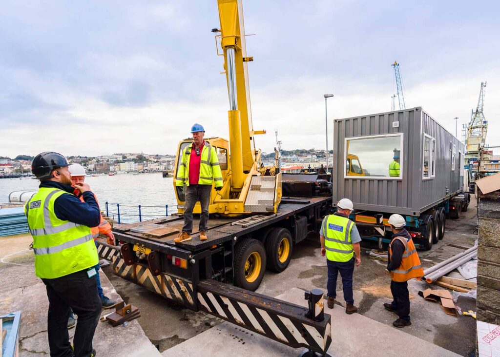guernsey harbours crane off loading container