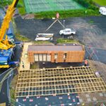 converted shipping container lifted into position