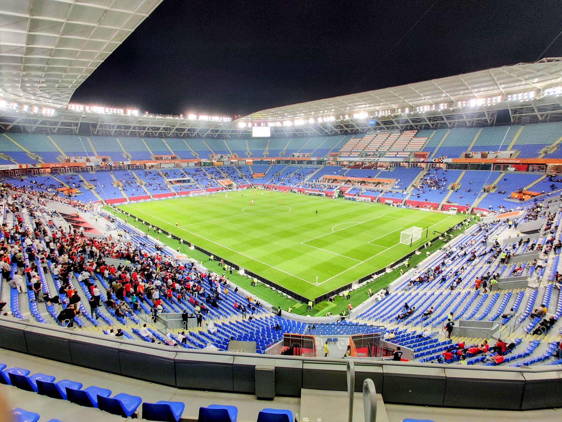 inside-stadium-974-world cup match warm up green grass flood lights