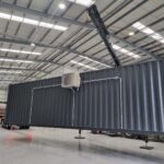 grey shipping -container crane large factory