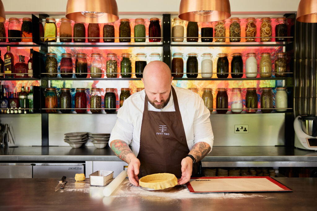 pastry chef preparing pie steel counter bar area