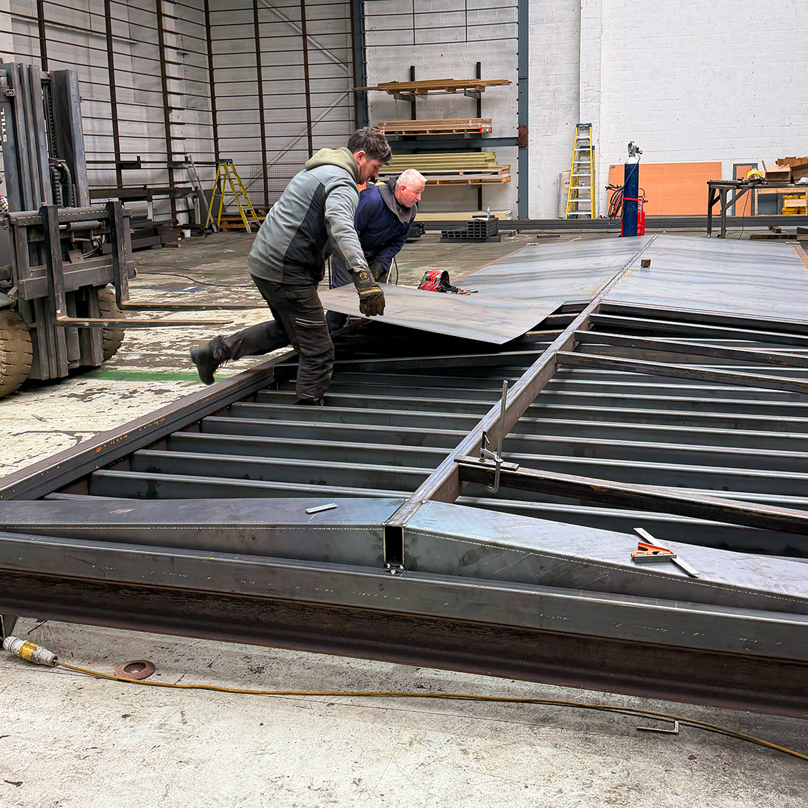 Laying steel roof sheets switch house container build