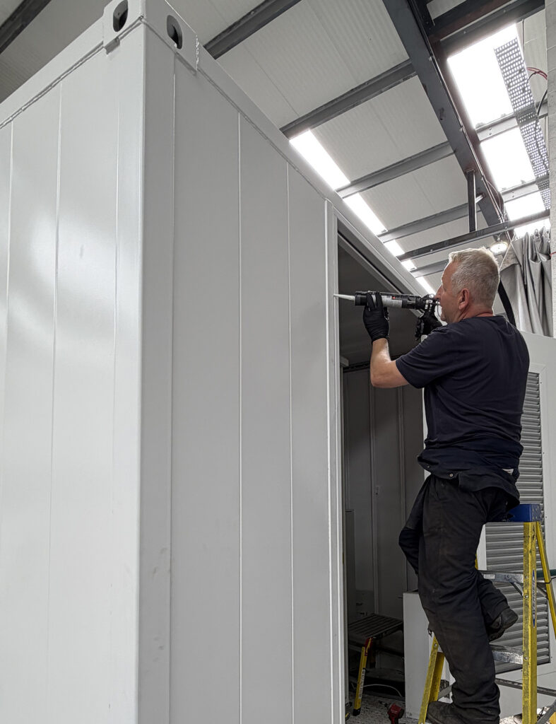Staff step ladder assembly attention to detail sealant work white shipping container building
