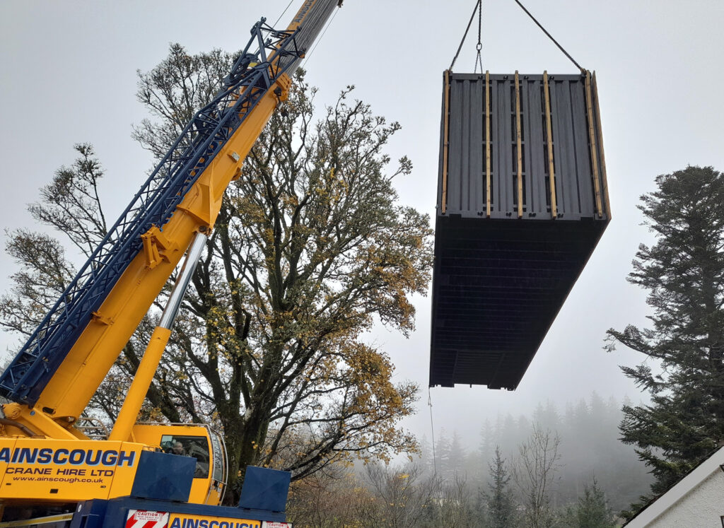 Container cottage in the woods craned installation