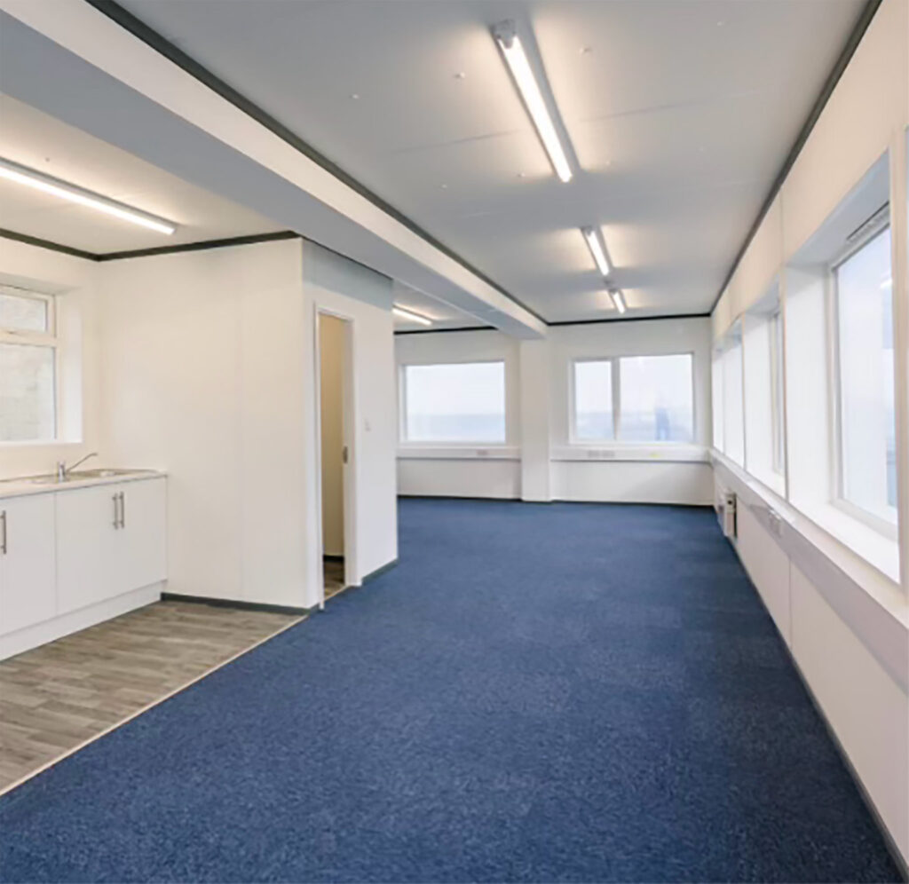 Office space blue carpet white walls modern shipping container conversion