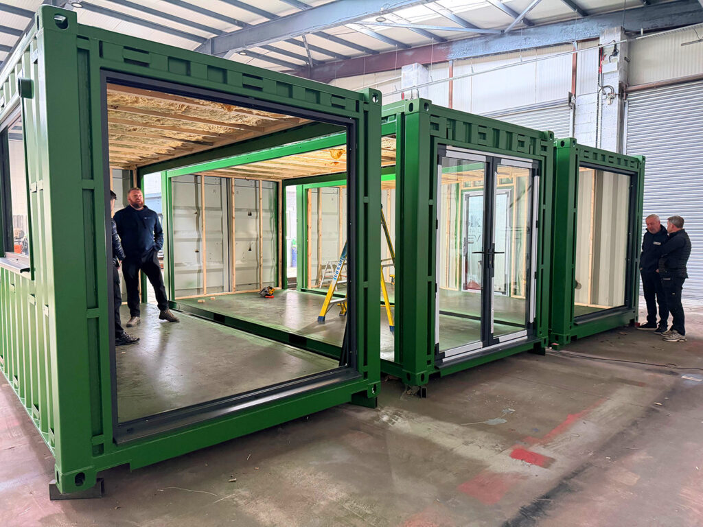 Expert modular building solutions green painted frames and glazing